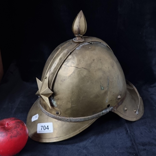 704 - A stunning antique brass Firefighters Helmet with star motif with vintage repairs.