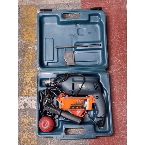 712 - A Black and Decker KD355RE 600 W electric drill with Draper tools drill bits. In original carry case... 