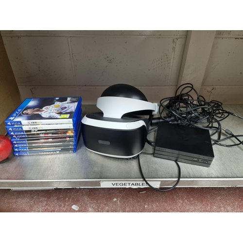 714 - A Sony Playstation VR headset. Lot also includes processor unit and camera along with 8 PS4 games.