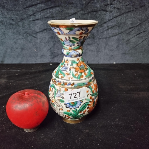 An attractive vintage hand made vase by Greek maker Icaros Rhodes. Boasting a flared rim and a cheerful floral design in shades of red, purple and green with gilt accents. With barely noticeable losses to rim and base.