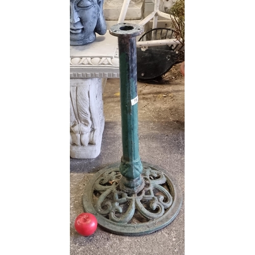 787 - A cast metal heavy garden parasol stand.