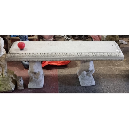 789 - A heavy reconstituted stone bench with egg and dart edge held on squirrel form plinths.