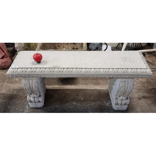 790 - A heavy reconstituted stone bench with egg and dart edge held on scroll plinths.