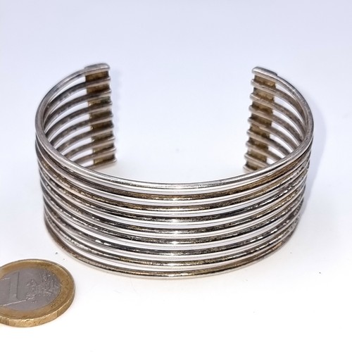 901 - A fabulous and heavy sterling silver (stamped 925) bangle, constructed of nine silver wires. 
Weight... 