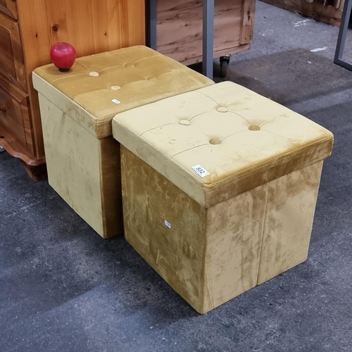 932 - A stylish pair of golden plush ottoman stools with button-tufted tops, offering both comfort and sto... 