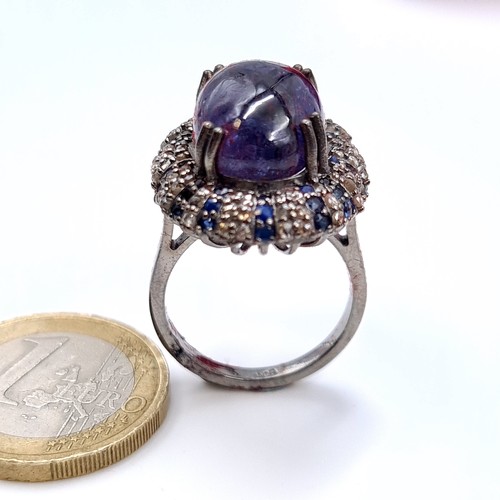 501 - Star Lot : A natural huge cabochon tazanite central stone 13.3 cts, weight of ring 8 grams, surround... 