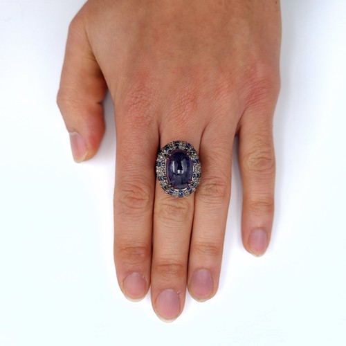 501 - Star Lot : A natural huge cabochon tazanite central stone 13.3 cts, weight of ring 8 grams, surround... 