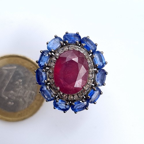 503 - Star Lot : A fabulous huge cabochon ruby  ring mounted  with 11 sapphires and diamond surround, rubi... 