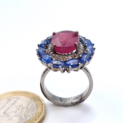 503 - Star Lot : A fabulous huge cabochon ruby  ring mounted  with 11 sapphires and diamond surround, rubi... 