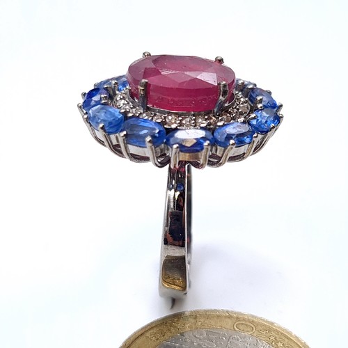 503 - Star Lot : A fabulous huge cabochon ruby  ring mounted  with 11 sapphires and diamond surround, rubi... 