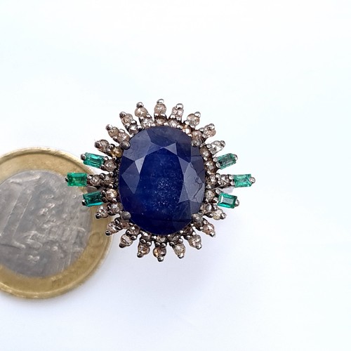 506 - Star Lot : A most attractive art deco style sapphire ring set with emerald and diamond sunburst surr... 