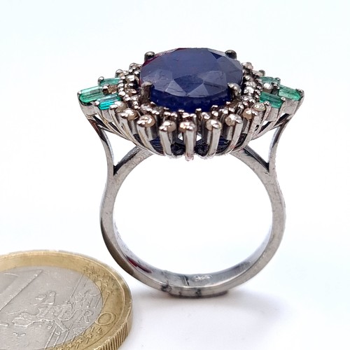 506 - Star Lot : A most attractive art deco style sapphire ring set with emerald and diamond sunburst surr... 