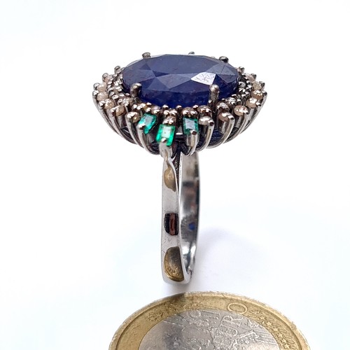 506 - Star Lot : A most attractive art deco style sapphire ring set with emerald and diamond sunburst surr... 