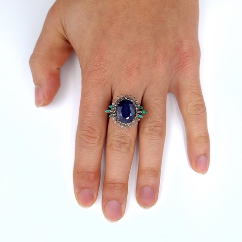 506 - Star Lot : A most attractive art deco style sapphire ring set with emerald and diamond sunburst surr... 