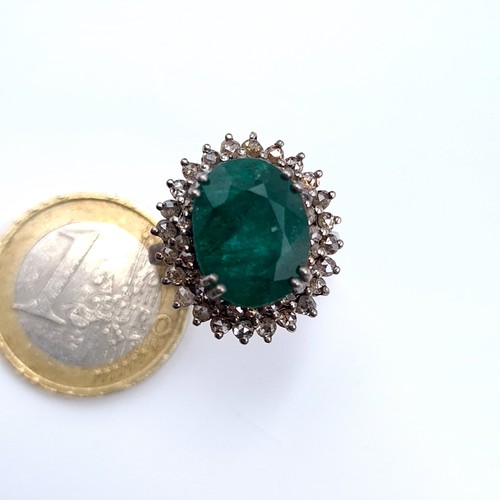 507 - Star Lot : A very fine emerald stone ring of 5.5 cts, with a diamond surround of 1 ct, ring mounted ... 