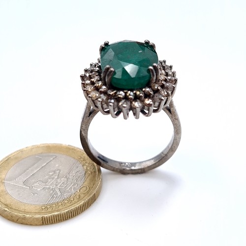 507 - Star Lot : A very fine emerald stone ring of 5.5 cts, with a diamond surround of 1 ct, ring mounted ... 