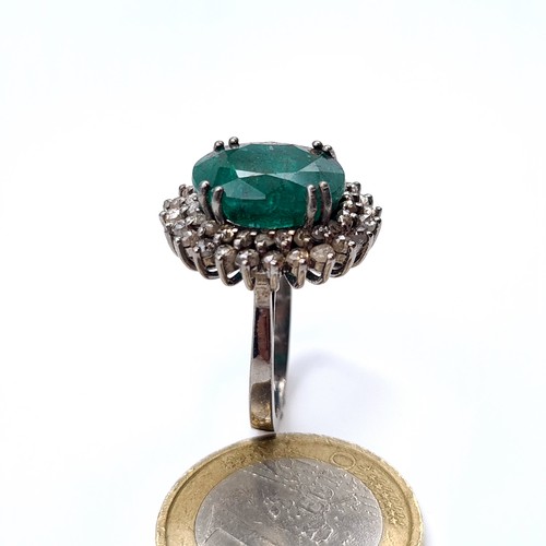 507 - Star Lot : A very fine emerald stone ring of 5.5 cts, with a diamond surround of 1 ct, ring mounted ... 