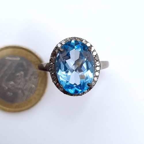 508 - Star Lot : A nice example of a blue topaz stone ring set with diamond surround mounted in a sterling... 