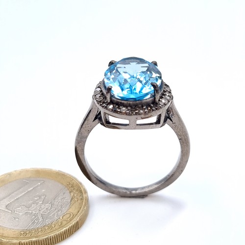 508 - Star Lot : A nice example of a blue topaz stone ring set with diamond surround mounted in a sterling... 