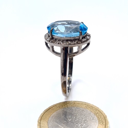 508 - Star Lot : A nice example of a blue topaz stone ring set with diamond surround mounted in a sterling... 