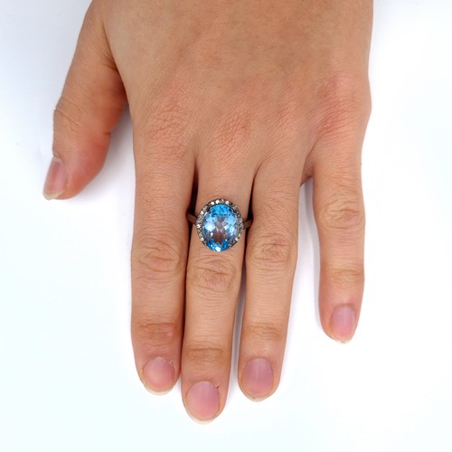 508 - Star Lot : A nice example of a blue topaz stone ring set with diamond surround mounted in a sterling... 