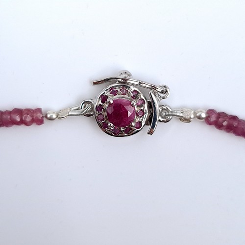 514 - A pretty ruby gemstone graduated necklace, set with am attractive sterling silver ruby stone set cla... 