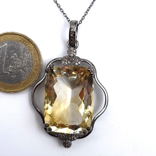 521 - A most attractive large citrine stone pendant set with diamond stone accents, length of chain 46cm, ... 