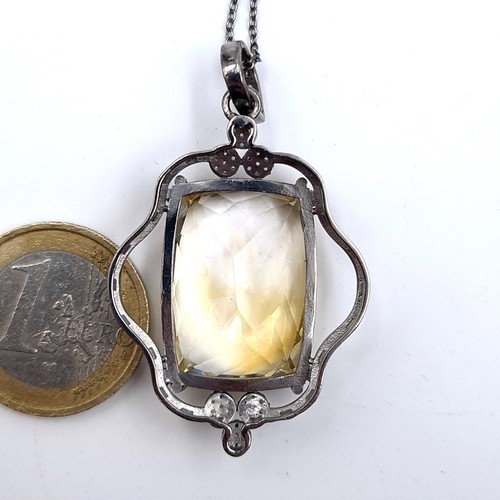 521 - A most attractive large citrine stone pendant set with diamond stone accents, length of chain 46cm, ... 