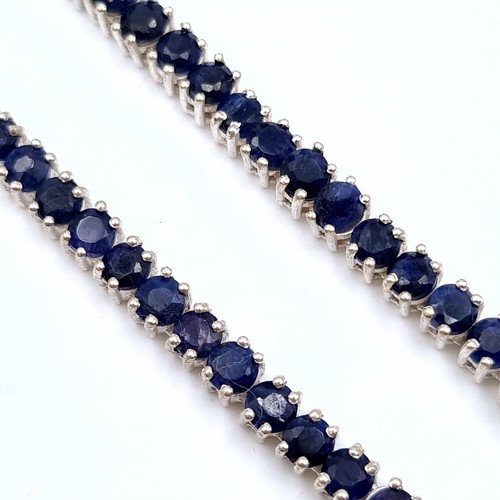 524 - Star Lot : A very nice example of a long sapphire stone necklace set in sterling silver, length of n... 