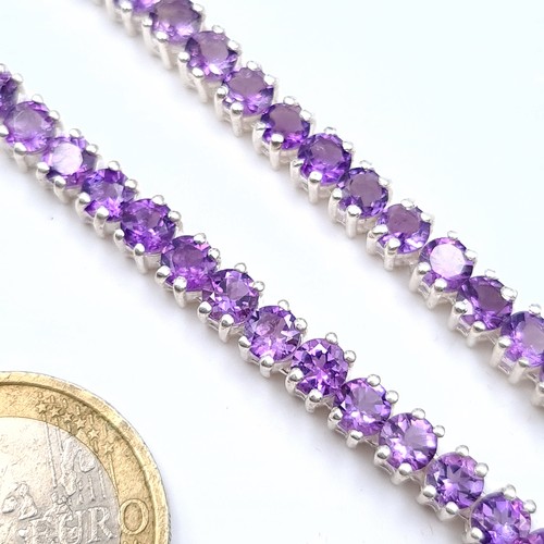 525 - A very nice example of a bright stoned amethyst necklace set in sterling silver, length 46cm, weight... 