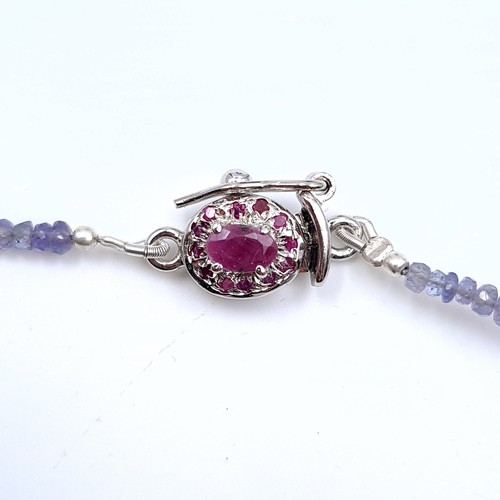 526 - An unusual graduated sapphire and ruby necklace set with a ruby sterling silver clasp, length 44cm, ... 