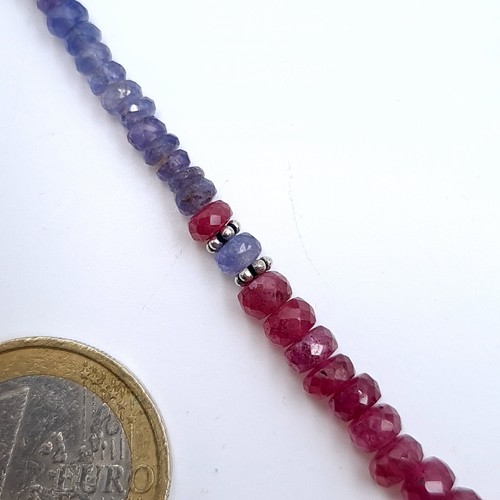 526 - An unusual graduated sapphire and ruby necklace set with a ruby sterling silver clasp, length 44cm, ... 