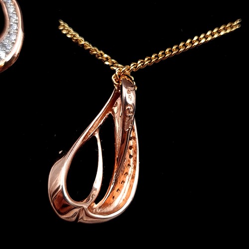 535 - A most attractive suite of rose gold toned jewellery consisting of a drop pendant with gem stone acc... 