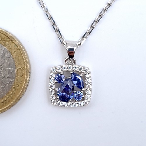 537 - A very nice example of a tazanite pendant necklace with gem stone surround together with a bright cu... 