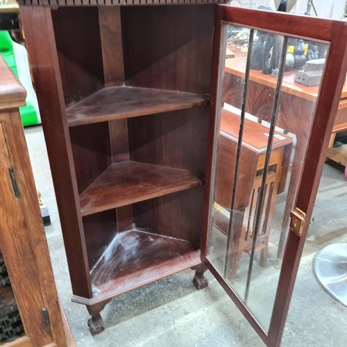 579 - A wonderful vintage mahogany corner unit boasting ball and claw feet and three internal shelves.