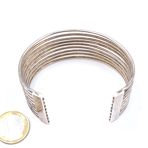 901 - A fabulous and heavy sterling silver (stamped 925) bangle, constructed of nine silver wires. 
Weight... 