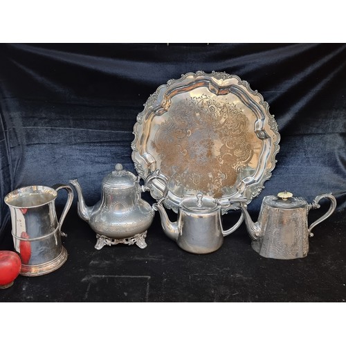 152 - Four elegant vintage silver plated items including a serving tray, ornate teapots and a beer stein w... 