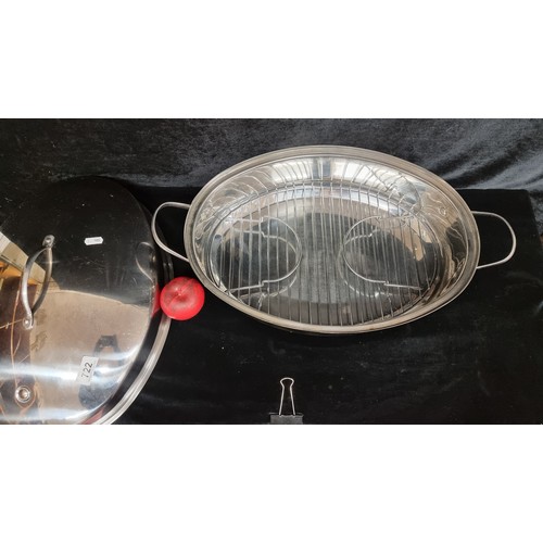 722 - A wonderful large 18 inch oval stainless steel roaster supplied with a raised and removable rack and... 