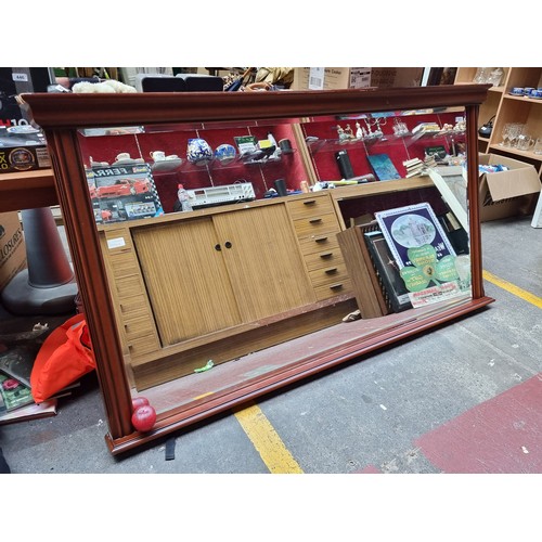 323 - Star Lot : A very large thick beveled mirror held in a stylish mahogany frame, substantial size for ... 