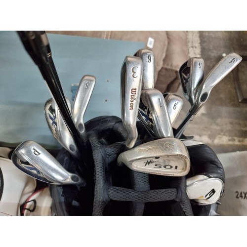 598 - Agood set of Calloway irons with two King Cobra drivers  all housed in a nice  Nike Extreme Sport ba... 