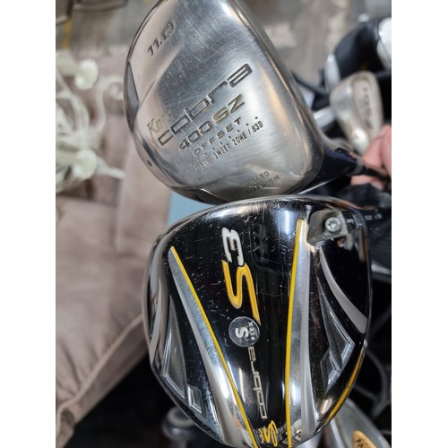 598 - Agood set of Calloway irons with two King Cobra drivers  all housed in a nice  Nike Extreme Sport ba... 