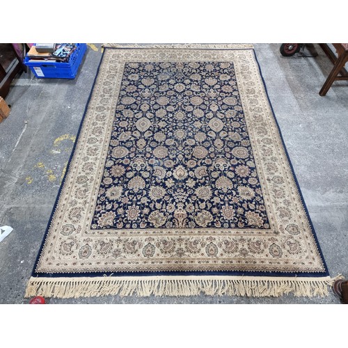 606 - A beautiful large rug featuring a floral design in shades of brown, red and navy. Its very soft and ... 