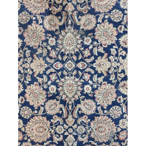 606 - A beautiful large rug featuring a floral design in shades of brown, red and navy. Its very soft and ... 