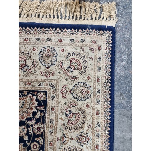 606 - A beautiful large rug featuring a floral design in shades of brown, red and navy. Its very soft and ... 