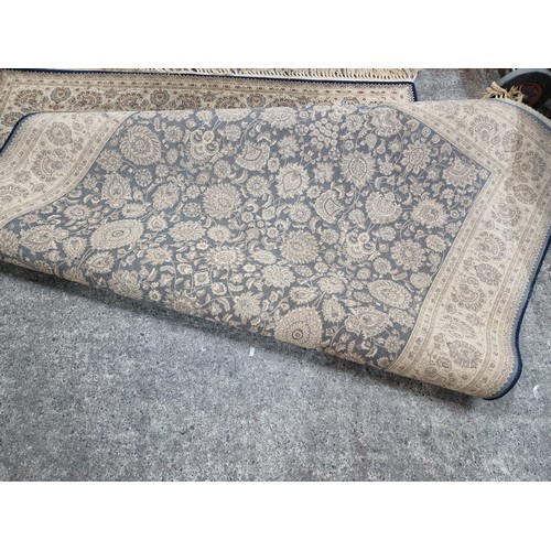 606 - A beautiful large rug featuring a floral design in shades of brown, red and navy. Its very soft and ... 