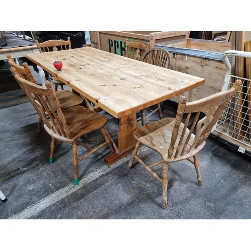 607 - Star Lot : A large stripped pine country kitchen table with five additional spindle back chairs.