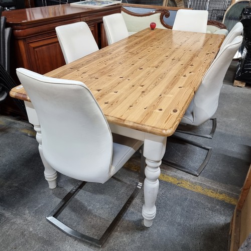 608 - Star lot : A large handsome country style table with six cream leather chairs. The table is in excel... 