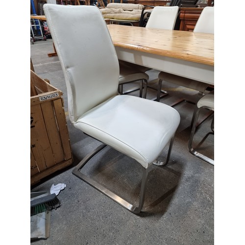 608 - Star lot : A large handsome country style table with six cream leather chairs. The table is in excel... 