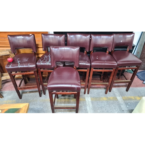 1002 - A set of six bar stools, upholstered in a burgundy leather fabric with lovely stud detailing. 5/6 fi... 