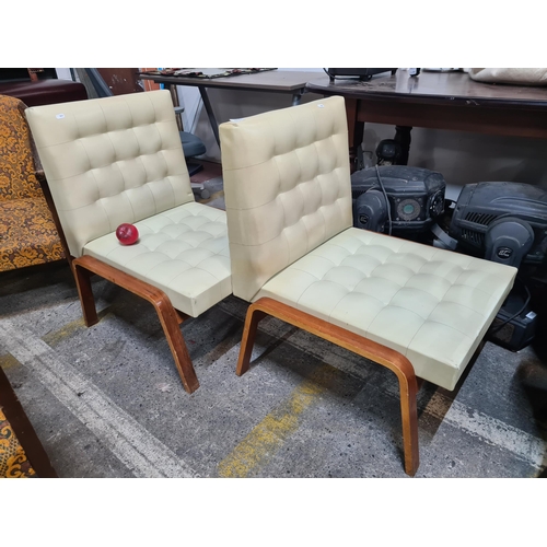 1015 - A super stylish pair of mid century designer chairs , upholstered in a fresh cream leather fabric an... 